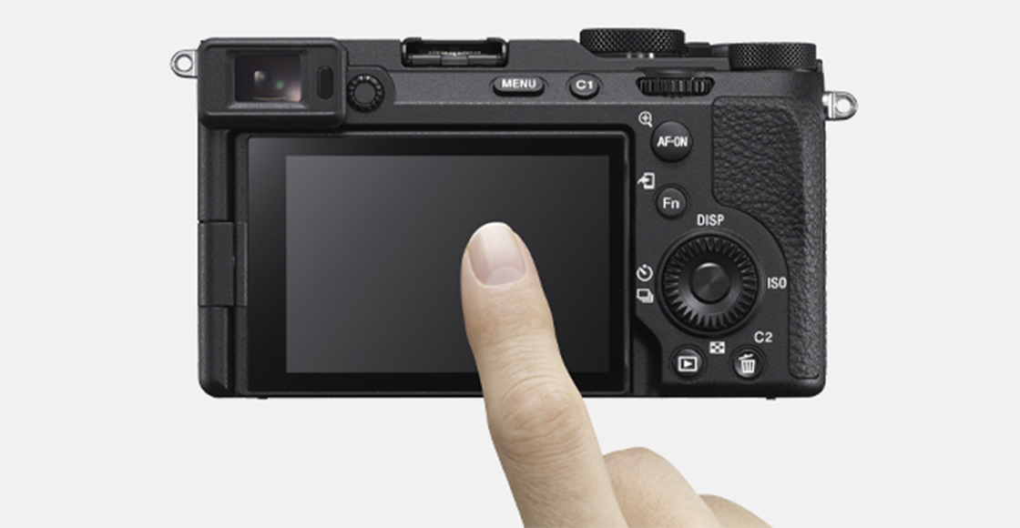 Product image showing rear view of camera with user’s finger operating touch screen