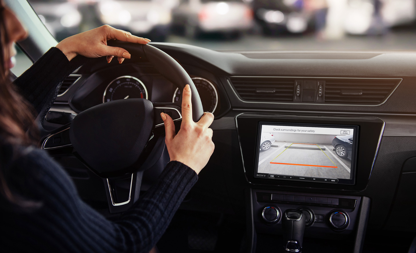 Front view of the XAV-AX3700 digital multimedia receiver installed on a car dashboard with the rear-view camera on the display.